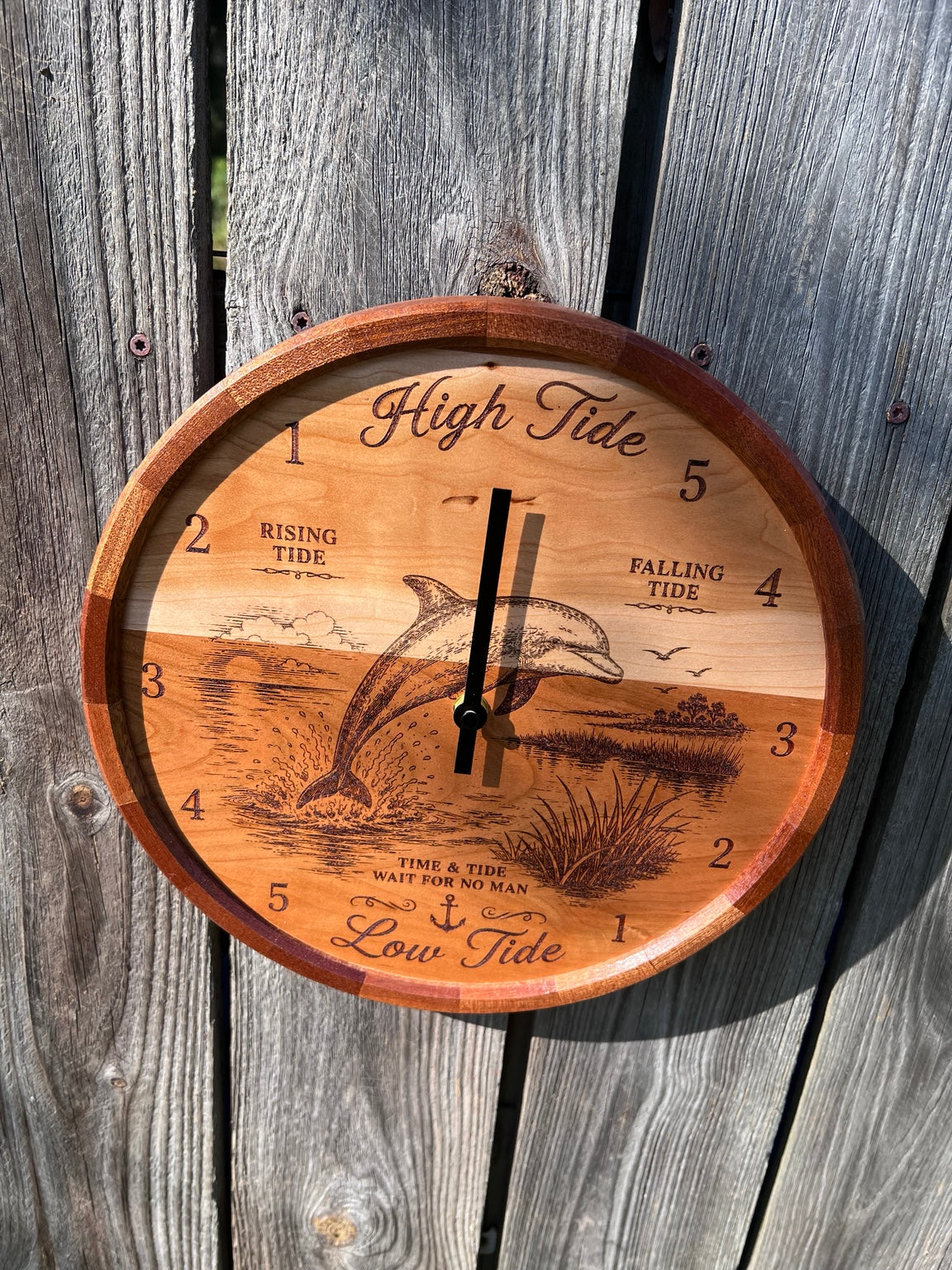 Front view of the dolphin tide clock with segmented sapele ring