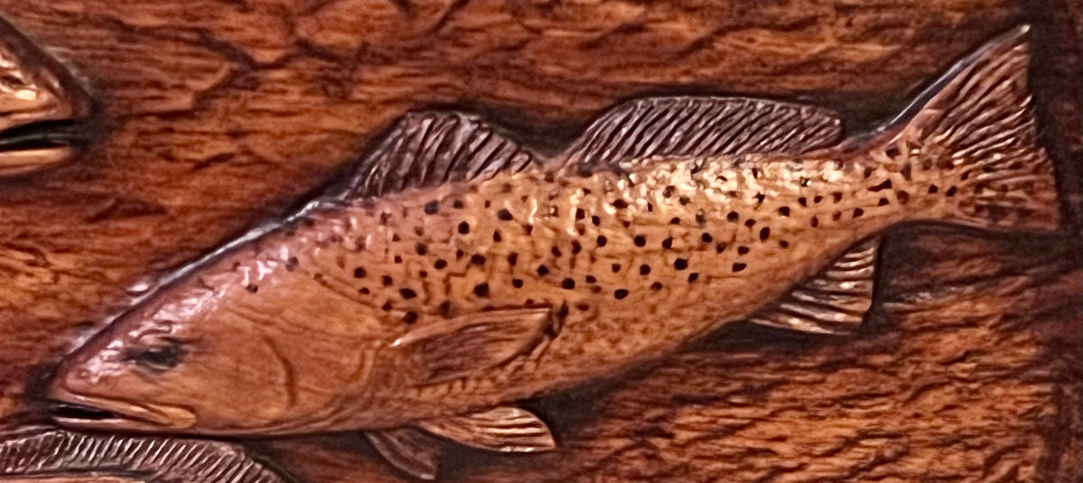 Close detail of spotted seatrout carving
