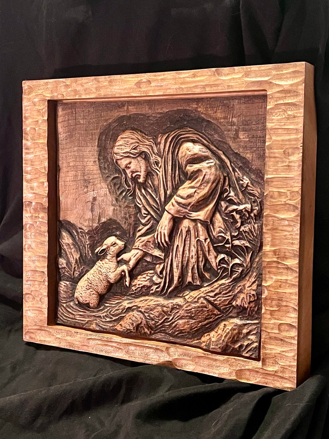Angled view of Good Shepherd wood relief