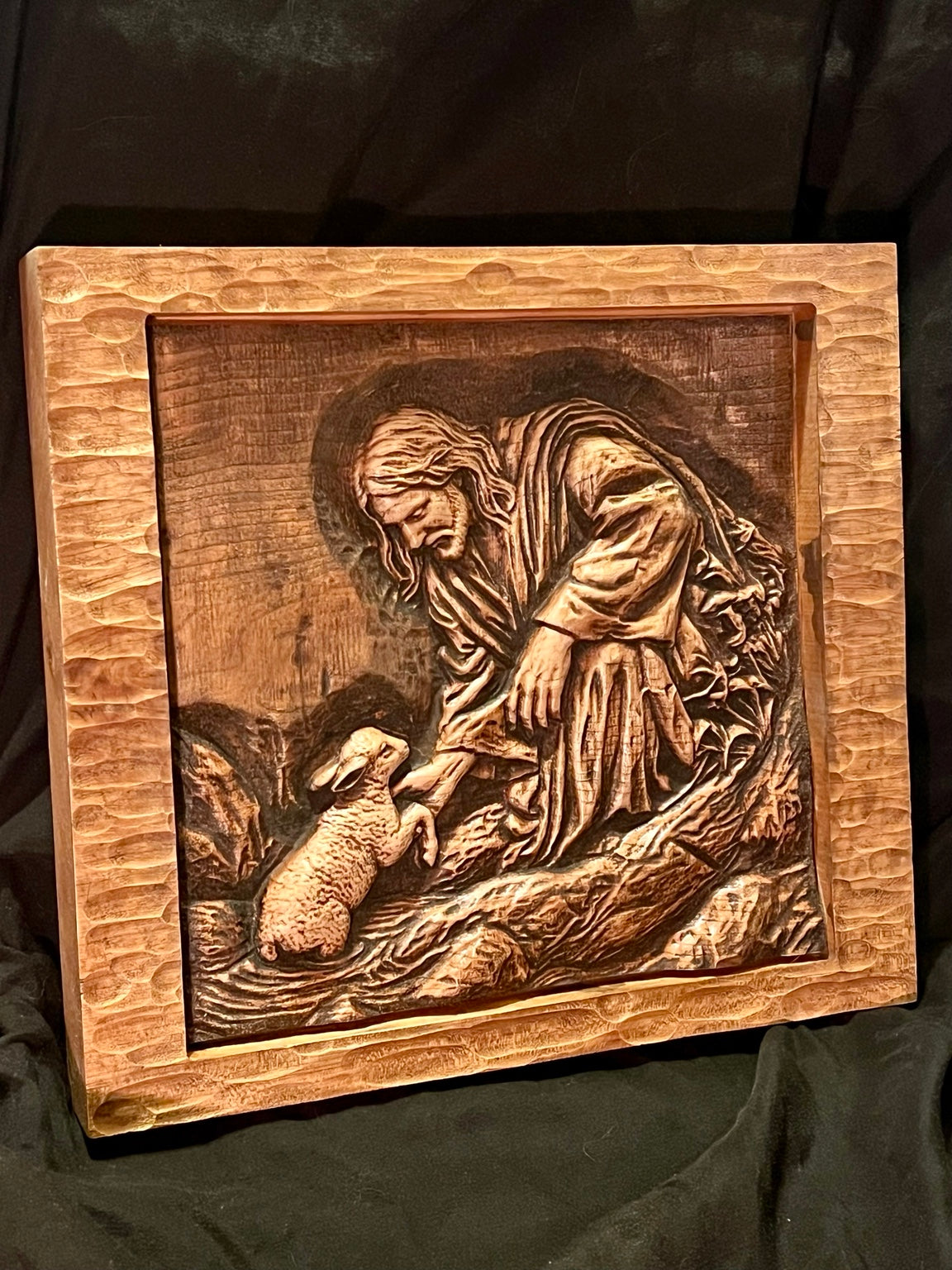 Side view of Good Shepherd wood relief