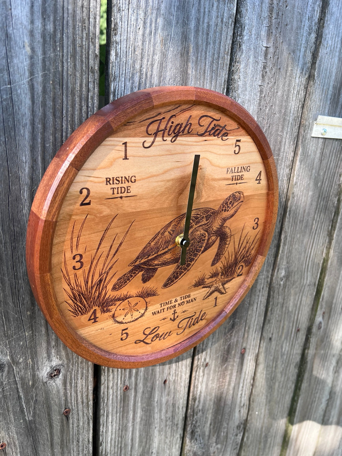 Angled view of the sea turtle tide clock showing the segmented sapele ring